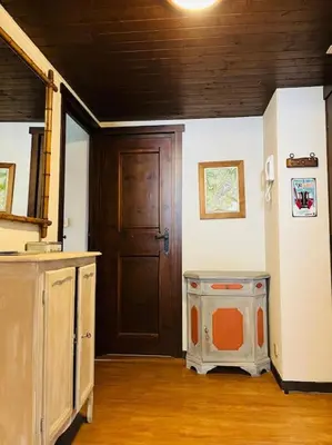 a room with a door and a dog in it at Duplex Le géant 7 voyageurs in Chamonix-Mont-Blanc