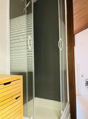 a shower with a glass door in a bathroom at Duplex Le géant 7 voyageurs in Chamonix-Mont-Blanc