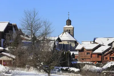 a town with snow covered buildings and a church at Les Eterlous 28 - Appt montagne 4 pers in Morillon
