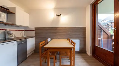 a kitchen with a wooden table and chairs at Les Eterlous 28 - Appt montagne 4 pers in Morillon
