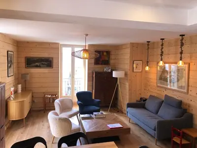 a living room with a couch and chairs and a table at Appartement Chamonix Centre - Vue Mont Blanc in Chamonix-Mont-Blanc