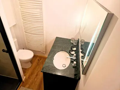 a bathroom with a sink and a toilet at Appartement Chamonix Centre - Vue Mont Blanc in Chamonix-Mont-Blanc