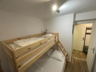 a bedroom with a bunk bed in a room at Résidence La Ruche-Appartement ISOARD (T2) in Les Carroz d'Araches