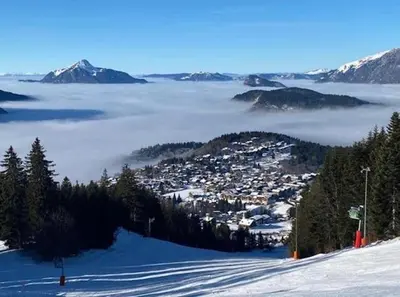 a view of a town in the snow with clouds at Résidence La Ruche-Appartement ISOARD (T2) in Les Carroz d'Araches