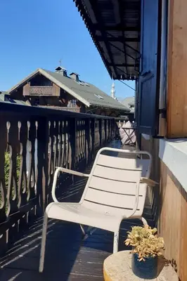 two white chairs sitting on a balcony with a table at Tatiana I in Megève