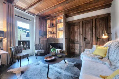 a living room with a couch and a table at Tatiana I in Megève