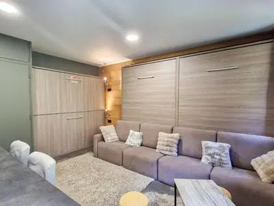 a living room with a couch with pillows at Studio rénové à Flaine, proche des pistes et commerces - FR-1-425-207 in Arâches-la-Frasse