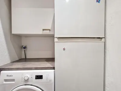 a kitchen with a white refrigerator and a washing machine at Studio rénové à Flaine, proche des pistes et commerces - FR-1-425-207 in Arâches-la-Frasse