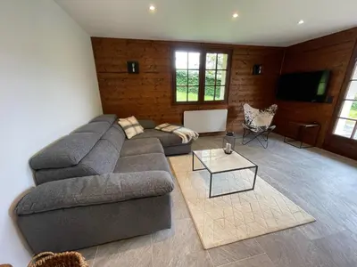 a living room with a couch and a table at Chalet de la buche croisée in Combloux