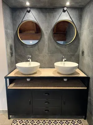 a bathroom with two sinks and two mirrors at Chalet de la buche croisée in Combloux