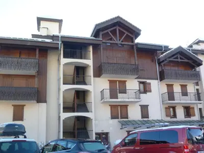 a building with cars parked in front of it at Grand T3 familial au cœur de Samoëns avec parking et wifi - FR-1-624-148 in Samoëns