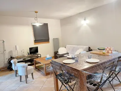 a living room with a table and a couch at Appartement T3 avec balcon et grande terrasse, proche centre et ski-bus, parking inclus - FR-1-624-149 in Samoëns