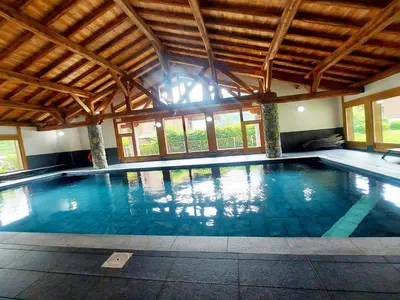 a large swimming pool in a large building with windows at Appartement T3 avec balcon et grande terrasse, proche centre et ski-bus, parking inclus - FR-1-624-149 in Samoëns