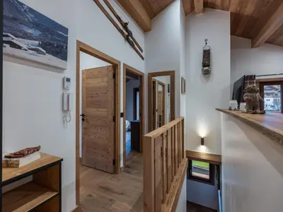 a hallway of a house with wooden doors at Appartement rénové au centre de Megève avec balcon et parking - FR-1-569-137 in Megève