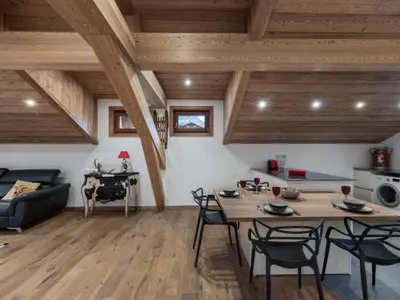 a kitchen and living room with a table and chairs at Appartement rénové au centre de Megève avec balcon et parking - FR-1-569-137 in Megève
