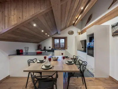 a kitchen and dining room with a table and chairs at Appartement rénové au centre de Megève avec balcon et parking - FR-1-569-137 in Megève