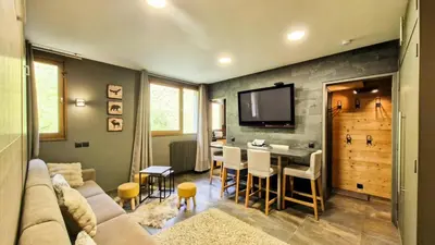 a living room with a couch and a table at Résidence Vega - Studio rénové · Proche des pistes et des commerces MAE-2831 in Magland