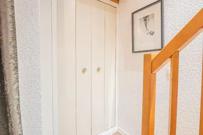 a hallway with white cabinets and a staircase at Chamour - A duplex apartment with Mont-Blanc view in Chamonix-Mont-Blanc