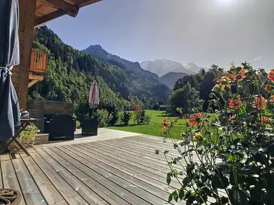 a wooden deck with a view of a mountain at Le Vivier in Saint-Gervais-les-Bains