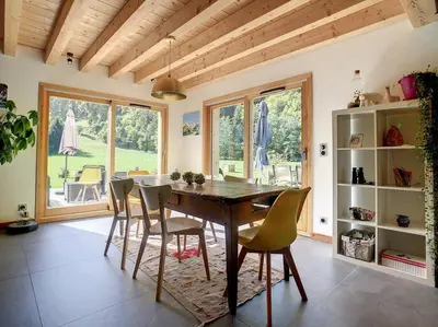 a dining room with a wooden table and chairs at Le Vivier in Saint-Gervais-les-Bains