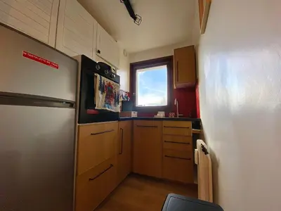 a small kitchen with a refrigerator and a window at Charmant appartement rénové au cœur de Samoëns, proche skibus - FR-1-624-145 in Samoëns
