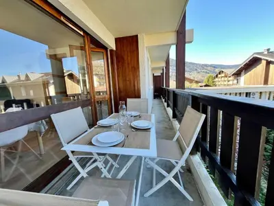 a table and chairs on the balcony of a house at Charmant appartement rénové au cœur de Samoëns, proche skibus - FR-1-624-145 in Samoëns