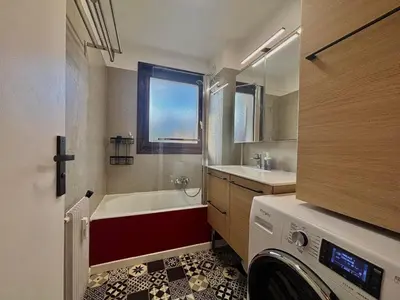 a bathroom with a tub and a sink and a washing machine at Charmant appartement rénové au cœur de Samoëns, proche skibus - FR-1-624-145 in Samoëns