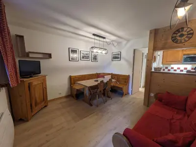 a living room with a table and a couch at Appartement cosy à Chamonix pour 4, balcon, parking - FR-1-343-250 in Chamonix-Mont-Blanc