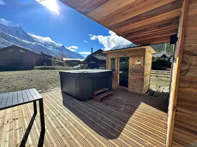 a wooden deck with a hot tub on a cabin at Chalets ASA 426 m2 in Chamonix-Mont-Blanc