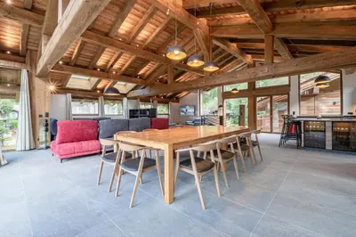 a dining room with a wooden table and chairs at Chalets ASA 426 m2 in Chamonix-Mont-Blanc