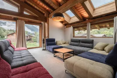 a living room with couches and a large window at Chalets ASA 426 m2 in Chamonix-Mont-Blanc
