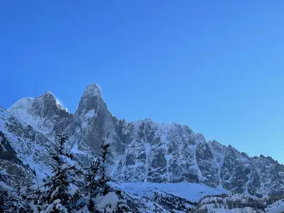a mountain covered in snow with a blue sky at Chalets ASA 426 m2 in Chamonix-Mont-Blanc