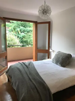 a bedroom with a bed and a large window at Modern and stylish 3-bedroom apartment with views - centre of St Gervais in Saint-Gervais-les-Bains
