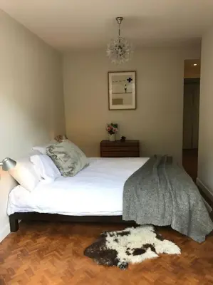 a bedroom with a large white bed with a blanket at Modern and stylish 3-bedroom apartment with views - centre of St Gervais in Saint-Gervais-les-Bains