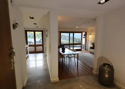 a living room with a table and a dining room at Modern and stylish 3-bedroom apartment with views - centre of St Gervais in Saint-Gervais-les-Bains