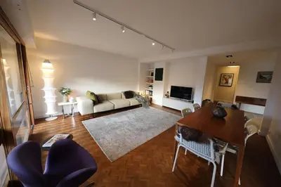 a living room with a couch and a table at Modern and stylish 3-bedroom apartment with views - centre of St Gervais in Saint-Gervais-les-Bains