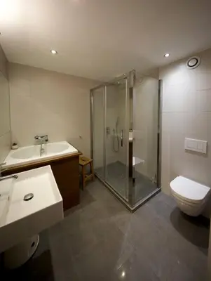 a bathroom with a shower and a toilet and a sink at Modern and stylish 3-bedroom apartment with views - centre of St Gervais in Saint-Gervais-les-Bains