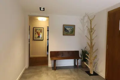 a hallway with a wooden bench in a room at Modern and stylish 3-bedroom apartment with views - centre of St Gervais in Saint-Gervais-les-Bains