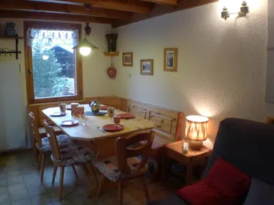 a dining room with a table and chairs and a window at Appartement 2 pièces avec mezzanine, casier à skis et parking privatif à Samoëns - FR-1-629-135 in Samoëns
