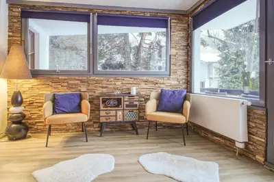 a living room with two chairs and a bathtub at Apartment Sierra in Chamonix-Mont-Blanc