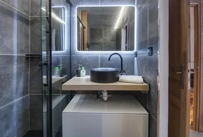 a kitchen with a sink and a clock on the wall at Apartment Sierra in Chamonix-Mont-Blanc