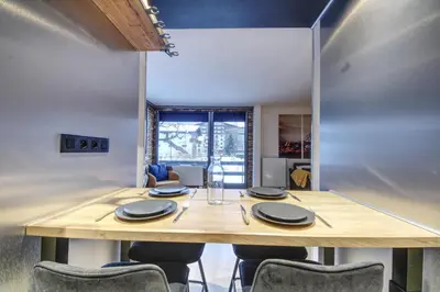 a living room with a couch and a table and chairs at Apartment Sierra in Chamonix-Mont-Blanc