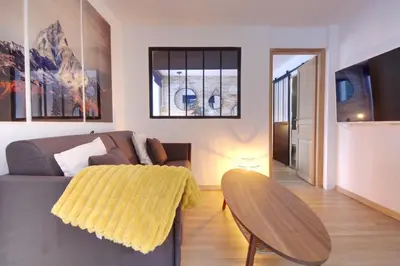 a living room with a couch and a table at Apartment Sierra in Chamonix-Mont-Blanc
