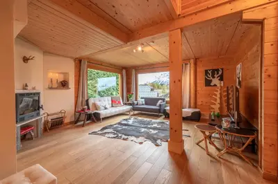 a living room with wooden floors and a wooden ceiling at Chalet aux Cerfs - Maison pour 10 vue montagne in Arâches-la-Frasse