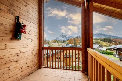 a balcony with a view of the mountains at Chalet aux Cerfs - Maison pour 10 vue montagne in Arâches-la-Frasse