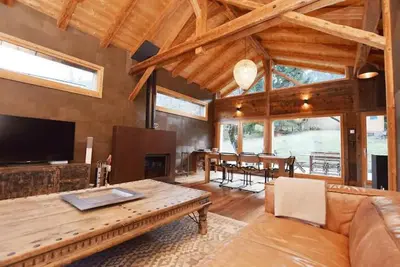 a large living room with a couch and a table at A 2 min du télécabine Chalet de charme 4 étoiles in Les Houches