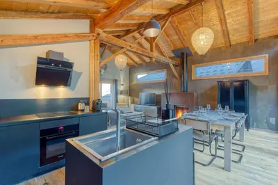 a kitchen and dining room with a table and chairs at A 2 min du télécabine Chalet de charme 4 étoiles in Les Houches