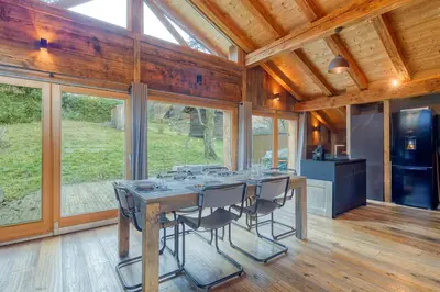 a large dining room with a table and chairs at A 2 min du télécabine Chalet de charme 4 étoiles in Les Houches