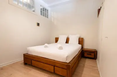 a bedroom with a bed with white sheets at Majestic - Appartement 2 pas du centre-ville Chamo in Chamonix-Mont-Blanc