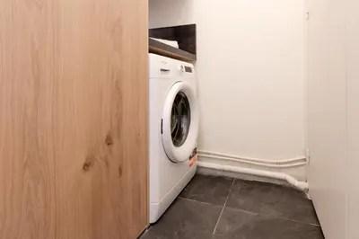 a white washer and dryer in a laundry room at Majestic - Appartement 2 pas du centre-ville Chamo in Chamonix-Mont-Blanc